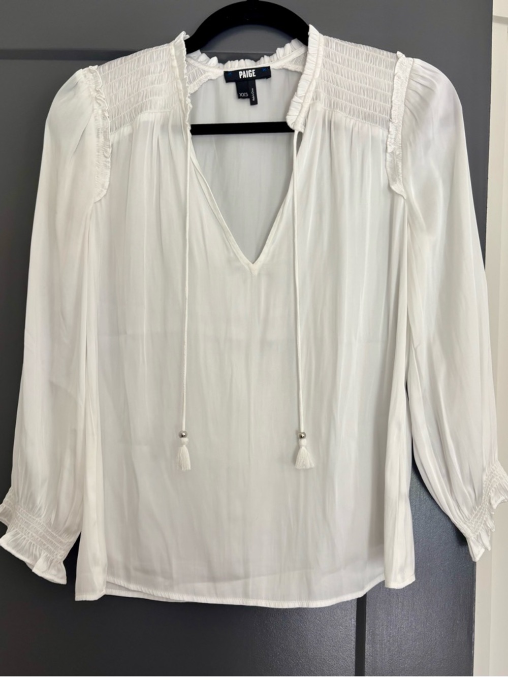 PAIGE White Smocked Yoke V‑Neck Blouse with Tassel Ties